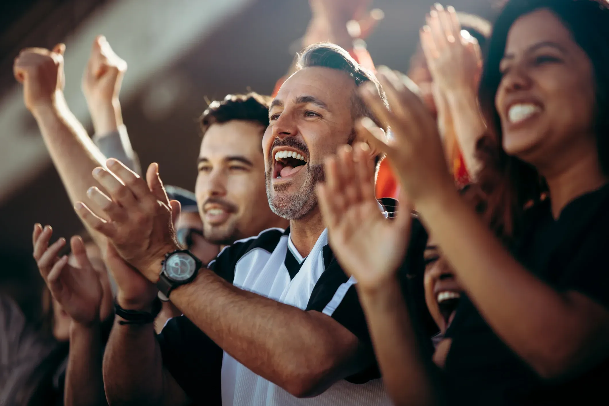 Excited football fans celebrating during a game-day moment